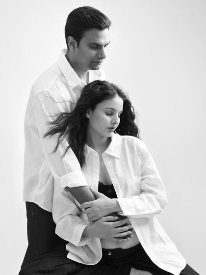 A moment of quiet intimacy. This black and white photo captures the couple in a gentle embrace, creating a timeless and romantic feel.