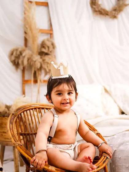 Sitting like a little prince in his rattan chair. This portrait is full of charm and personality.