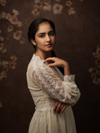 "You don't make art...you find it." This portrait, with a floral background, feels like a found moment of beauty, captured forever.