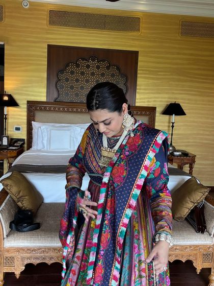 The client looking down, showing the detail of the front braids. This style keeps the hair off the face while still looking festive and traditional.