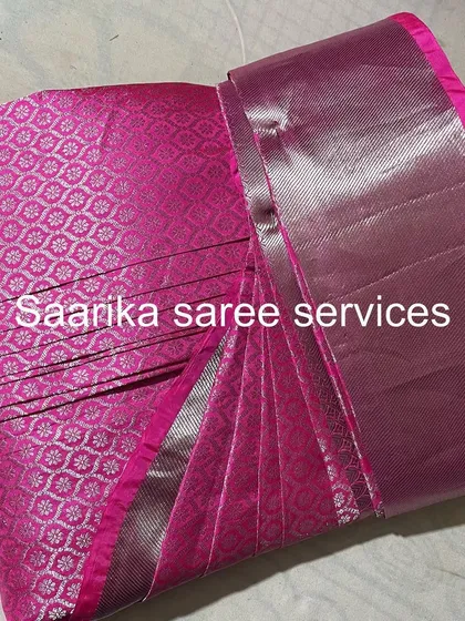 A bright pink saree with a silver border, perfect for parties.