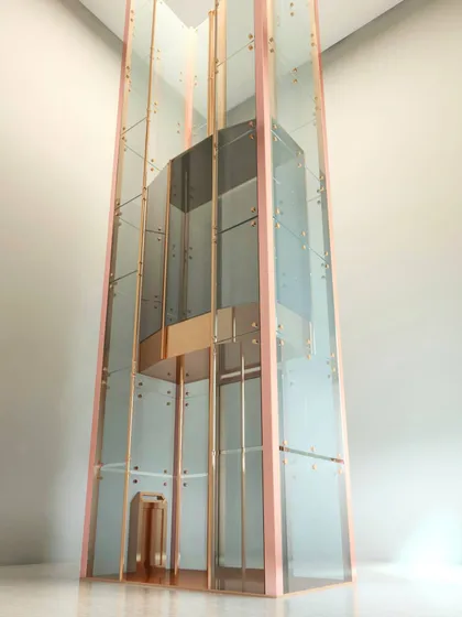 For a truly unique touch, I designed this capsule glass lift for Preeta Elevators Inc. The rose gold finish and transparent structure make it a stunning architectural feature, not just a functional elevator.