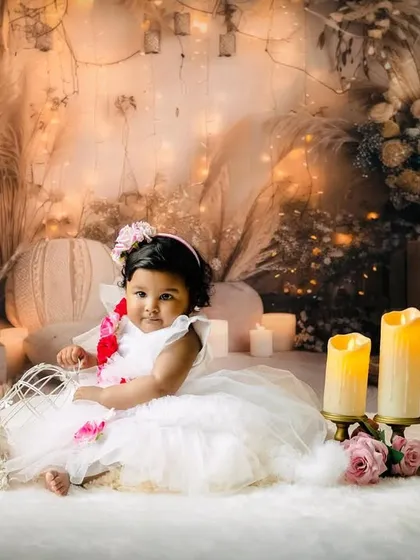 An example of a dreamy and elegant pre-birthday photoshoot. For this session with Sarveksha, we used soft lighting, candles, and a beautiful floral backdrop to create a magical, fairytale atmosphere. I can create any theme you imagine for your child's portraits.