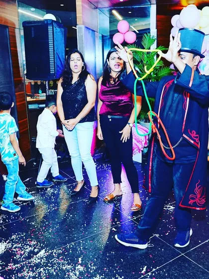 The linking rings forming an impossible shape. This is a classic piece of magic that captivates both adults and children at private parties.