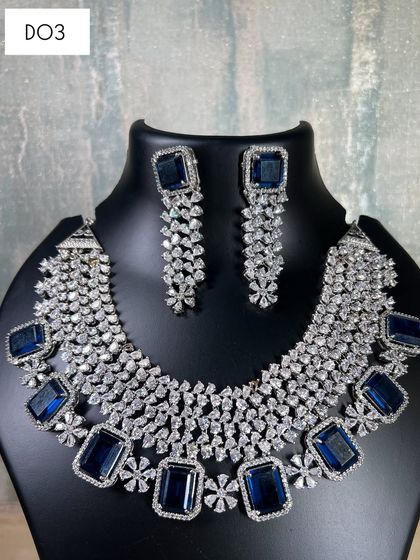 A still photo of the magnificent blue stone and diamond choker. The craftsmanship is clear in this image, showing a high-quality piece available for rent.