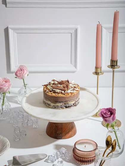 A new take on our Baileys ice cream cake, set on an elegant table with pink roses. A sophisticated treat for any occasion.