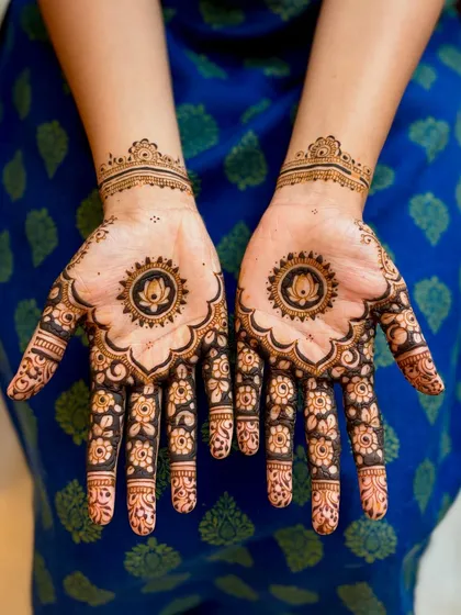 Sometimes, less is more. This minimalist mehendi design features a beautiful lotus mandala in the center of the palm, with delicate floral patterns on the fingers. It's a modern and chic option for any celebration.