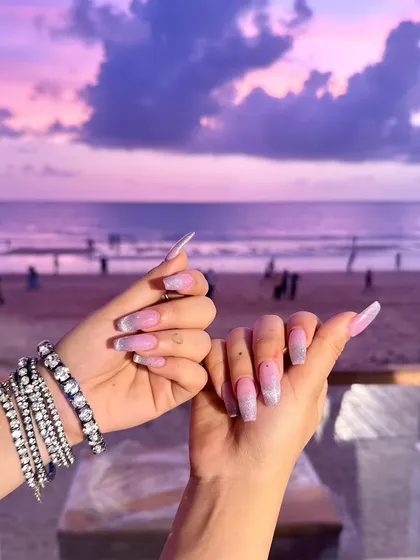 The full view of these stunning sunset-inspired nails. The long, elegant shape and sparkling finish are pure magic.