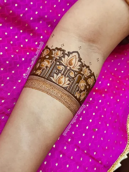 A practice arm-band featuring a beautiful lotus garden motif. This demonstrates our skill in creating detailed floral patterns.