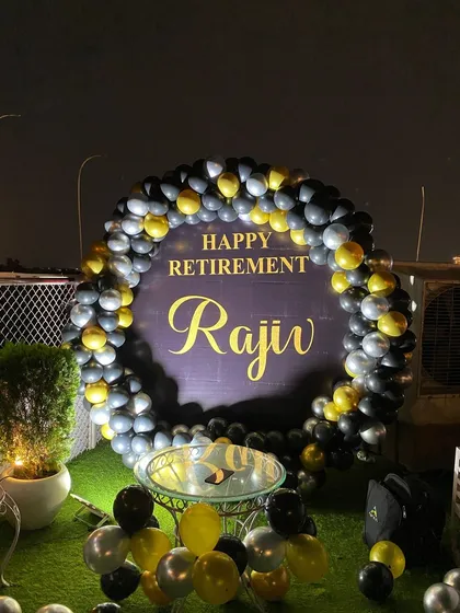 A close-up of the 'Happy Retirement' sign inside the balloon ring.