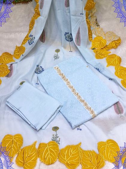 A unique unstitched suit set in light blue with a stunning yellow leaf-patterned applique dupatta. This is a perfect example of how a creative dupatta can elevate a simple suit.
