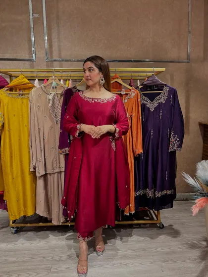 This pose captures the elegance of the wine-colored suit. The asymmetrical hemline of the kurta adds a modern flair, making it a standout piece for any festive wardrobe.