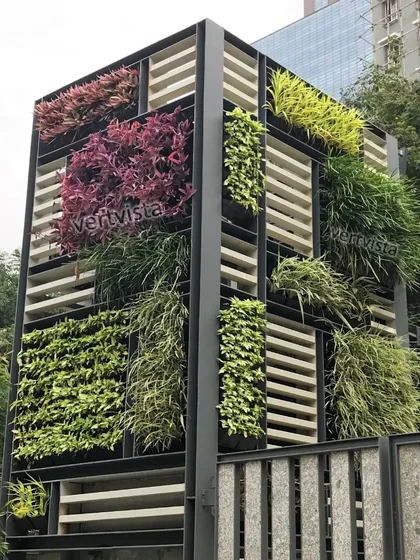 Our designs go beyond simple walls. This custom-built outdoor structure uses a modular framework to create a living sculpture, showcasing a diverse mix of plant species with varied colors and textures for a dynamic, architectural green statement.