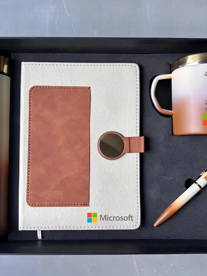 This two-tone cream and brown set for Microsoft shows another color variation. It includes a diary with a card holder, a matching pen, and a dual-color insulated mug, all neatly fitted into a custom box.