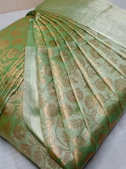 This light green saree with gold floral motifs is another example of my work. I ensure the pleats are neat and the saree is ironed for a polished finish.