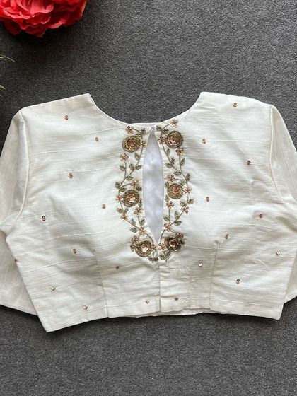 The full back view of the white handwork blouse, a perfect blend of simplicity and elegance.