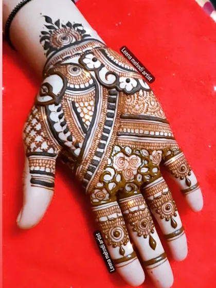 A detailed and intricate design for a wedding guest. The pattern is dense with paisleys, florals, and fine-line work, creating a very rich and full appearance.