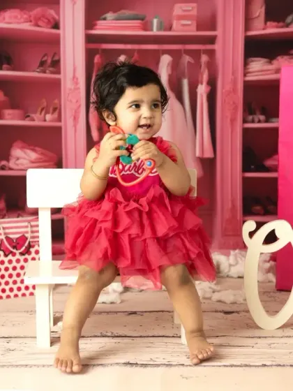 A little girl celebrating her first birthday, Barbie style. I provide the costume and props to make her milestone shoot extra special and vibrant.