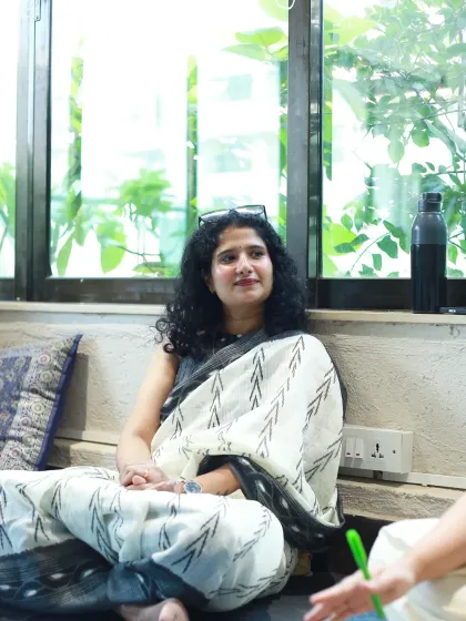 Candid photography for a professional event. This shot was taken at a Mumbai doula meetup, capturing one of the attendees in a relaxed, natural moment of conversation. This style is perfect for documenting corporate or community events authentically.