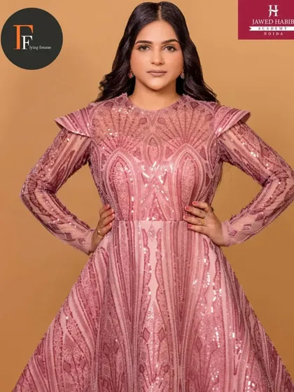 A closer view of the model in the detailed pink gown, highlighting the intricate makeup.