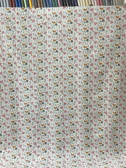 A full view of the charming backing fabric for the red and white star quilt.