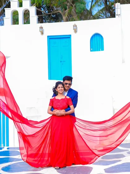 A creative pose with the bride's red gown spread out like wings. We love getting artistic to make your pre-wedding photos unique.