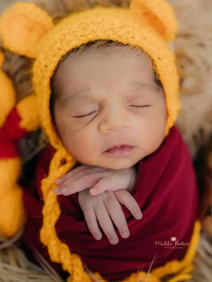 This little one is dreaming of the Hundred Acre Wood. The cozy textures and warm colors make this Winnie the Pooh setup perfect for a newborn.