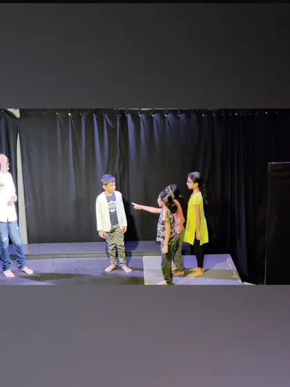 Young actors in the middle of a scene they wrote themselves, showing their creativity and teamwork.