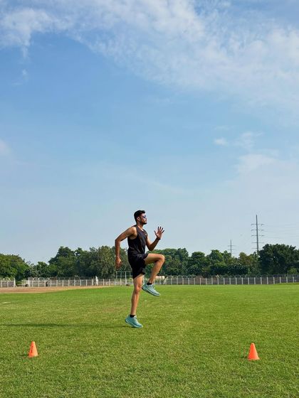 Executing a high-knee sprint drill. This focuses on developing powerful hip drive and proper running mechanics, which are essential for efficient sprinting and acceleration on the field.