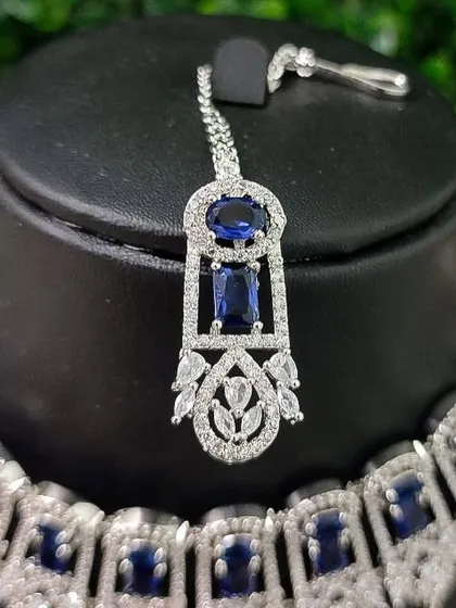 The maang tikka from the blue AD set, designed to perfectly complement the necklace and earrings.