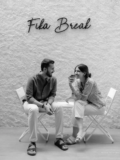 Taking a "Fika Break" together. This black and white shot from a cafe-themed pre-wedding shoot is simple, charming, and tells a story of shared routines.