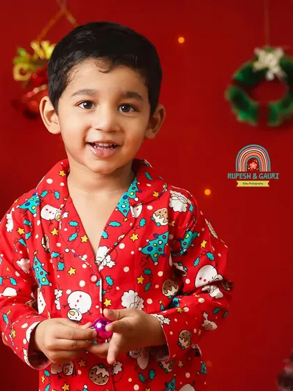 A sweet portrait of a little boy in his Christmas pajamas, ready to celebrate the festive season in our studio.