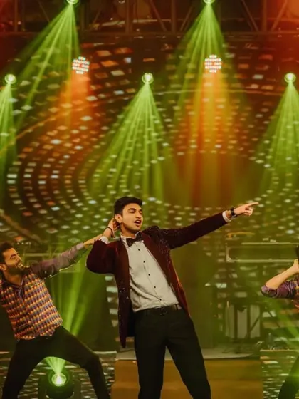 The groom and his backup dancers in full performance mode. The lighting and stage effects were designed to make this solo act feel like a professional concert.