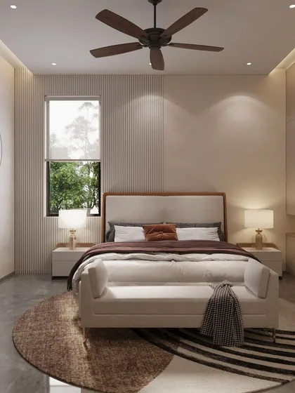 A second view of the minimal and classy bedroom, focusing on the sleeping area. The design uses a simple, clean-lined bed frame, a plush bench, and a large geometric rug to create a sense of calm and understated luxury.