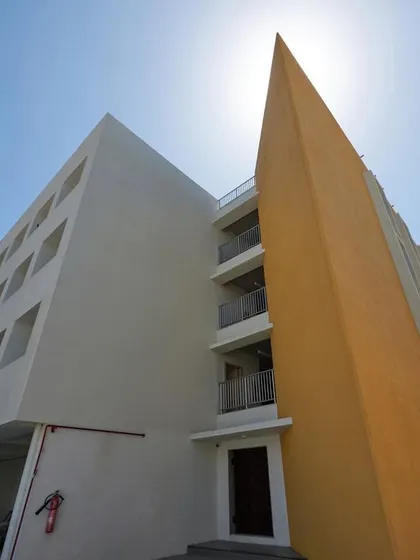 A recently completed skill development center in Ankleshwar. The architectural design uses bold color and form, with a striking yellow angular wall creating a strong visual identity.