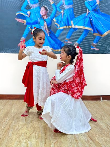 A candid moment between two of our young performers during the Janmashtami event. We foster friendships and a supportive environment among our students.