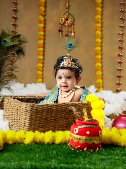 Our little Krishna is ready for Janmashtami! The peacock feathers, flower garlands, and traditional props create a vibrant and authentic festive scene.