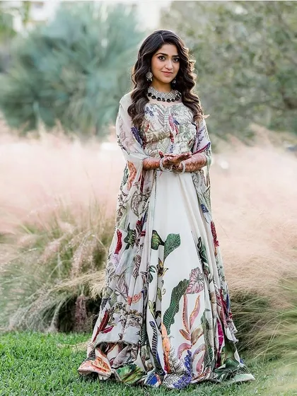 A solo shot of the bride in her stunning floral-printed Sangeet lehenga. The outfit is a perfect blend of traditional silhouette and modern print.