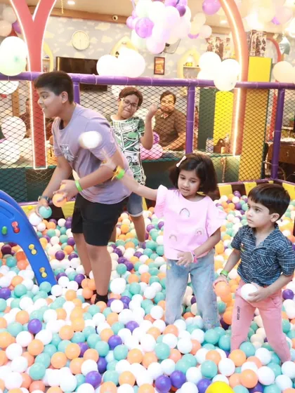 A candid shot of kids having a blast together in the ball pit. It's a wonderful space for making new friends and sharing laughs.