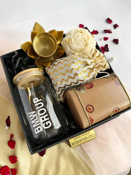 This sleek black gift box was created for the BMW Group. It features a branded glass tumbler, premium chocolates, and a lotus diya, showcasing our ability to create sophisticated gifts for luxury brands.