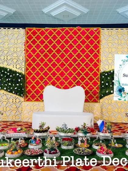 An elegant engagement platter setup in Annur. The red and gold stage decor is complemented by my traditional seer varisai arrangement on the grass floor.
