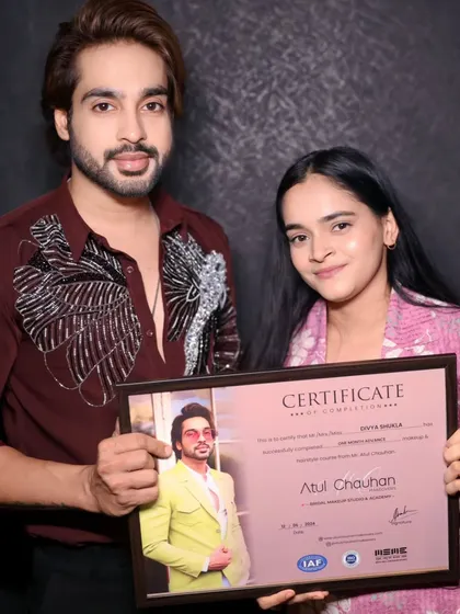 A student proudly holding her certificate of completion. Another success story from the academy.