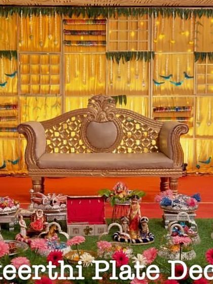 A colorful and grand baby shower setup at Anandhaas Hotel. The display includes a variety of props like a miniature swing and Ferris wheel to match the joyous occasion.