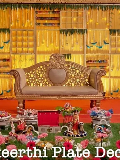 A colorful and grand baby shower setup at Anandhaas Hotel. The display includes a variety of props like a miniature swing and Ferris wheel to match the joyous occasion.