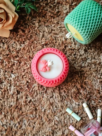 Something beautiful is glowing your way. This is my Mesh Pattern Candle, shown here in a lovely pink with a delicate wax bow on top. You can customize the color to match your decor.