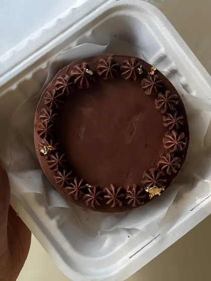 Our bento cakes are perfect for smaller, intimate celebrations. This one features a rich chocolate ganache with delicate piping and gold leaf details.