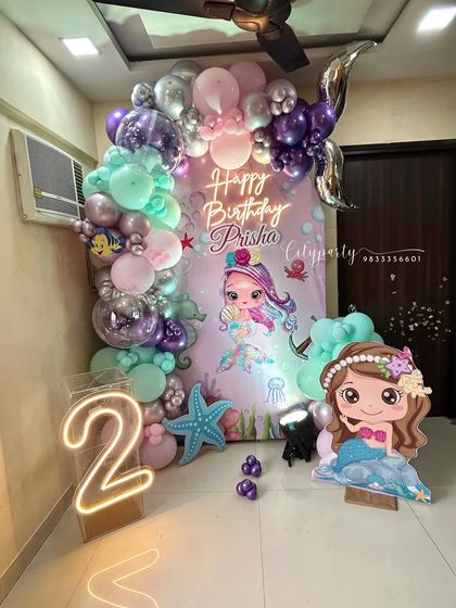 The complete mermaid theme setup for a home birthday party, including the light-up number '2'.