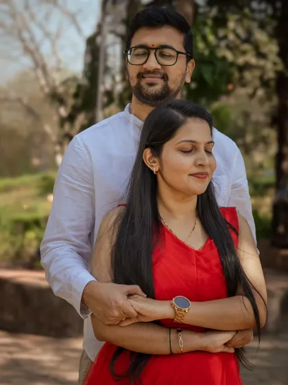 A warm and intimate embrace from behind. This pose is perfect for a post-wedding shoot, conveying a sense of comfort, protection, and quiet love.