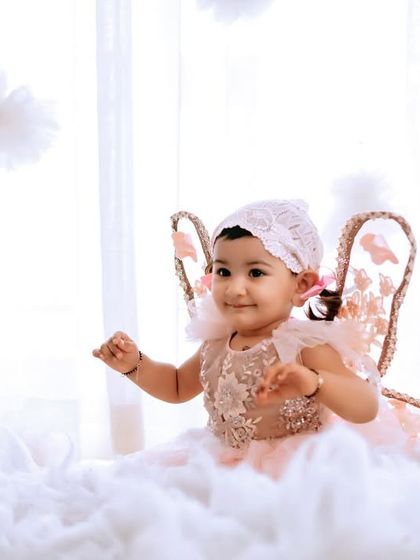An angel sitting on a cloud. This dreamy and ethereal setup with soft cotton clouds and fairy wings is perfect for a heavenly baby portrait.