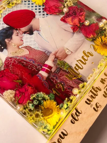 A close-up of the bestselling block art, highlighting the vibrant flowers and the couple's romantic photo.